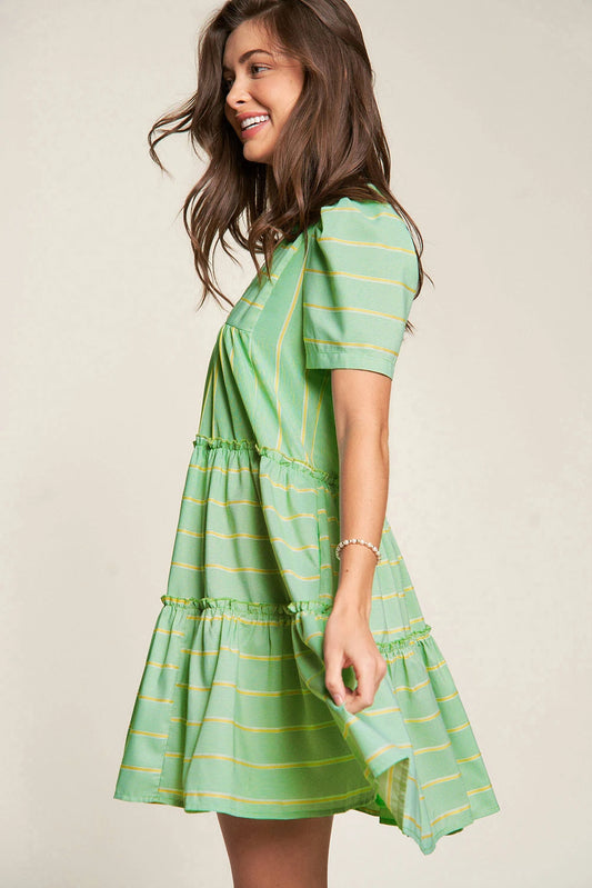 Add a playful touch to your wardrobe with The Pricillas dress. Featuring a flattering V-neck, delicate frill details, and a tiered silhouette, this dress offers a perfect balance of fun and femininity. The fresh green stripes bring a vibrant, breezy feel, making it ideal for sunny days and effortless style.