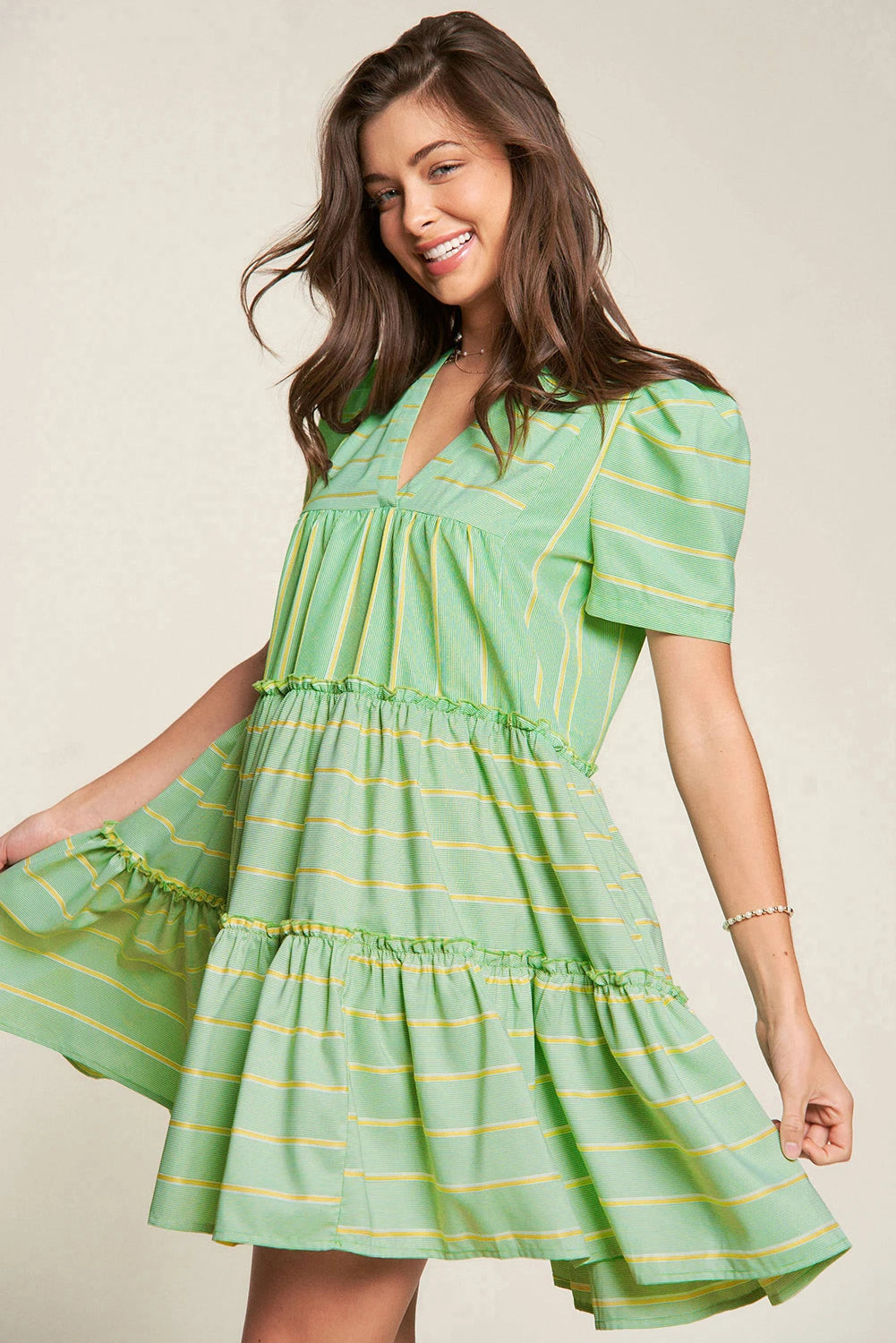 Add a playful touch to your wardrobe with The Pricillas dress. Featuring a flattering V-neck, delicate frill details, and a tiered silhouette, this dress offers a perfect balance of fun and femininity. The fresh green stripes bring a vibrant, breezy feel, making it ideal for sunny days and effortless style.