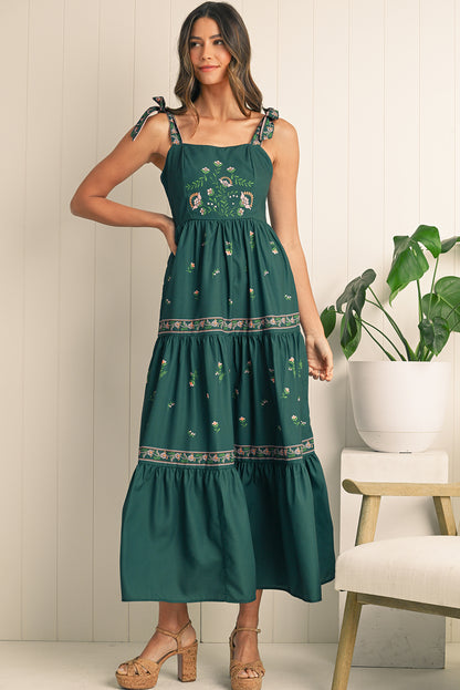 Turn heads in this blackish green boho floral sleeveless dress with a trendy waist knot detail for a bohemian vibe. The vibrant floral print adds femininity, perfect for summer outings or casual gatherings. Stay cool and stylish with the sleeveless design, offering comfort and freedom of movement. The flattering silhouette works for any occasion, pairing with heels for nights out or sandals for daytime looks.