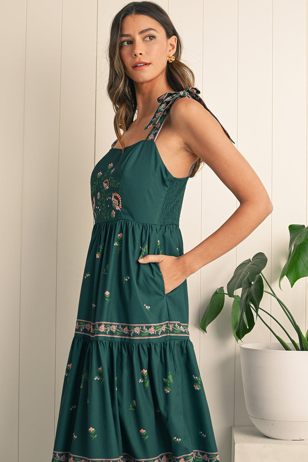 Turn heads in this blackish green boho floral sleeveless dress with a trendy waist knot detail for a bohemian vibe. The vibrant floral print adds femininity, perfect for summer outings or casual gatherings. Stay cool and stylish with the sleeveless design, offering comfort and freedom of movement. The flattering silhouette works for any occasion, pairing with heels for nights out or sandals for daytime looks.