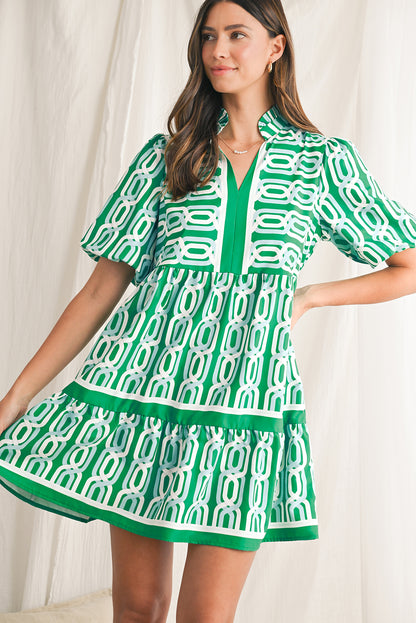 Vibrant green hue with an eye-catching abstract print, perfect for making a bold statement in any setting. V-neckline adds a touch of femininity, while puff sleeves bring a trendy and playful element to the design. Flirty mini length enhances the legs and silhouette, ideal for showcasing your style with confidence. Boho-inspired frill detailing along the neckline and hemline adds a touch of whimsy and charm to the overall look.