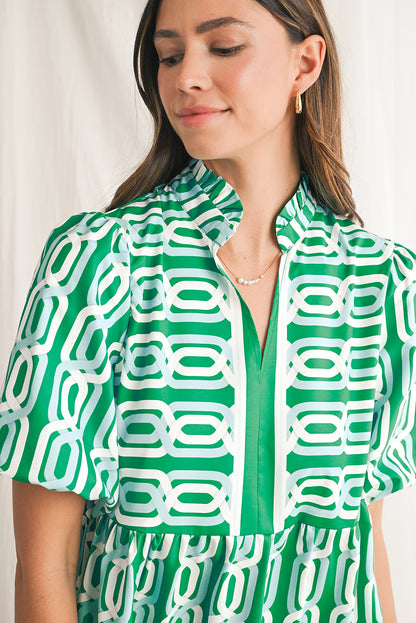 Vibrant green hue with an eye-catching abstract print, perfect for making a bold statement in any setting. V-neckline adds a touch of femininity, while puff sleeves bring a trendy and playful element to the design. Flirty mini length enhances the legs and silhouette, ideal for showcasing your style with confidence. Boho-inspired frill detailing along the neckline and hemline adds a touch of whimsy and charm to the overall look.