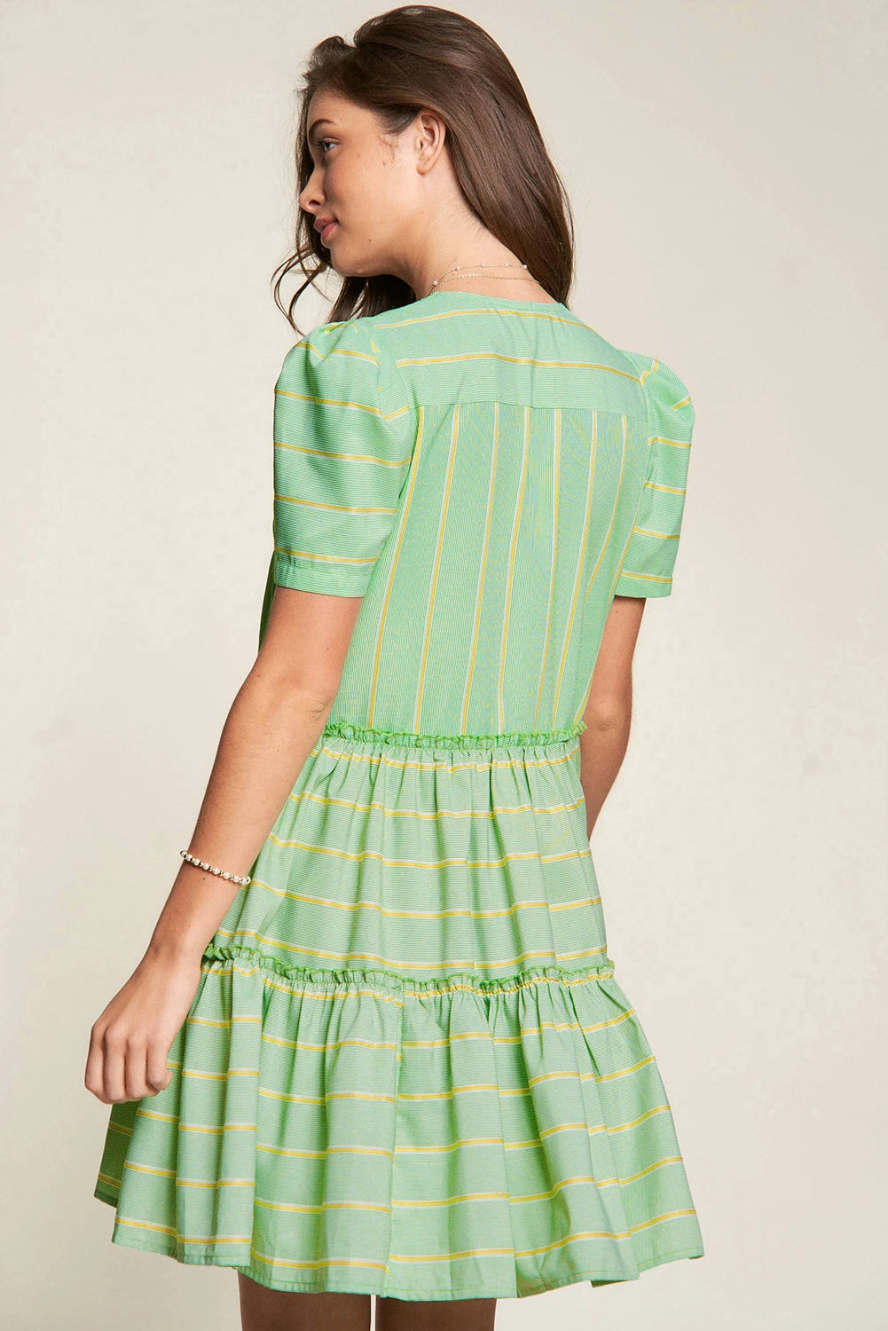 Add a playful touch to your wardrobe with The Pricillas dress. Featuring a flattering V-neck, delicate frill details, and a tiered silhouette, this dress offers a perfect balance of fun and femininity. The fresh green stripes bring a vibrant, breezy feel, making it ideal for sunny days and effortless style.