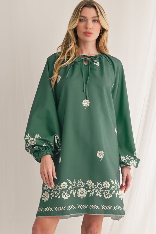 This dress showcases a unique knot detail for a charming bohemian style. Convenient pockets allow you to carry essentials easily, making it suitable for any occasion. Its refreshing mist green hue pairs beautifully with the vibrant floral print for an eye-catching look. The flattering V-neck design enhances your neckline, adding a flirty touch to your outfit