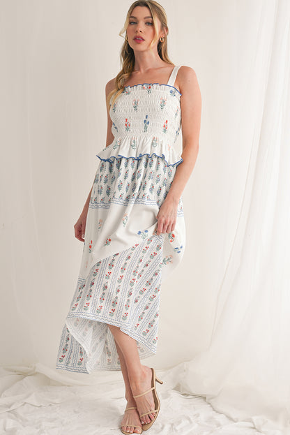 White Floral Print Boho Dress with elegant frill details for a stylish, feminine look. Smocked bodice ensures a flattering fit and all-day comfort. Flowing ruffle hem adds a romantic, bohemian touch. Fresh floral print on white, perfect for spring, summer, or casual occasions.