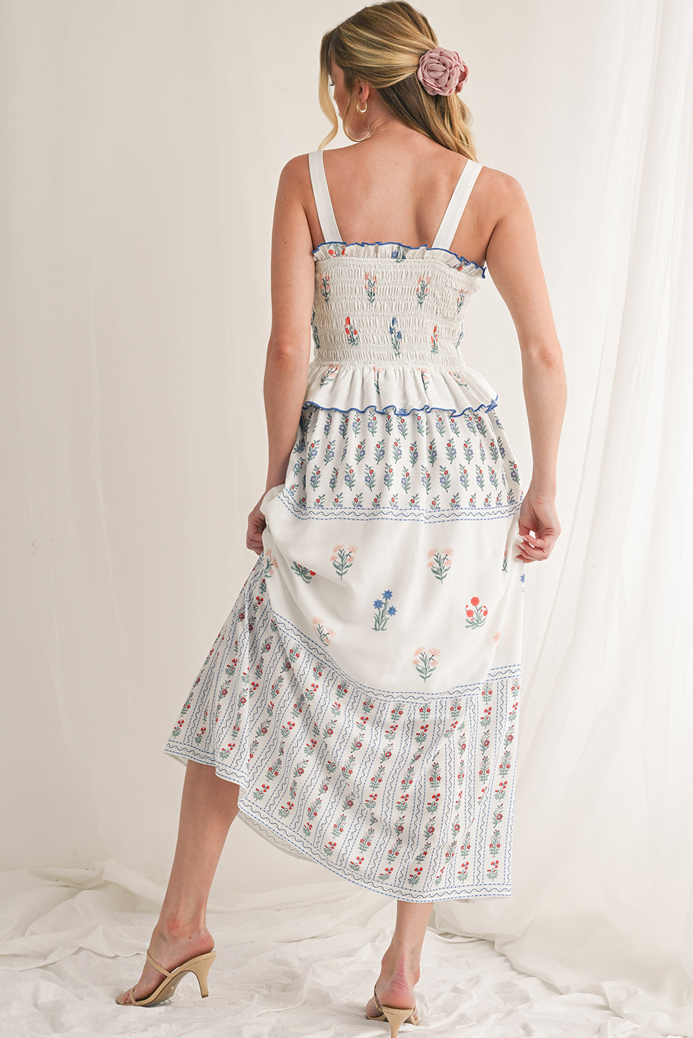 White Floral Print Boho Dress with elegant frill details for a stylish, feminine look. Smocked bodice ensures a flattering fit and all-day comfort. Flowing ruffle hem adds a romantic, bohemian touch. Fresh floral print on white, perfect for spring, summer, or casual occasions.